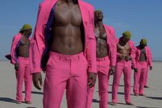 a group of men in pink suits and hats