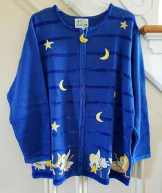 A very gently worn Vintage QUACKER FACTORY Women's Celestial Theme Embellished Cardigan Sweater in excellent condition. LUSH embroidered, patched and knit angels decorated with pearl beads and irradescent gold sequins, front and back. Patch and bead stars and moons. Golden thread highlights. Soft monotone velour striped front and trim. Christmas, Xmas? Cute? Ugly? Either way, you gotta love it! 53% Ramie 35% Cotton 8% Rayon 4% Acrylic. Size 1X. Armpit to armpit: 25" Length, shoulder to hem: 29". Wave Clipart, Moon Sweater, Star Clothing, Embellished Cardigan, Stars Moon, Zip Cardigan, Blue Angels, Sequins Embroidery, Moon Stars