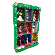 a colorful display case filled with lots of different items on top of a white surface