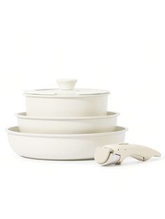 three white dishes stacked on top of each other with one bowl in the middle and two bowls at the bottom