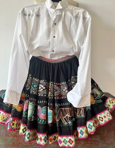 Vintage Peruvian embroidered festival wool skirt above the  knee length floral - ties on both sides. Hand made. Measures as follows: Waist 20 flat -ties on both sides Length 20 In excellent vintage as found condition -no smells or tears.    Authentic Andean Peruvian Textile. *Please note that this skirt has led a previous life, and may tell a story through minor imperfections. You may feel confident though that you're making a positive choice to care for the planet when buying it!i Embroidered Fitted Skirt For Fall, Fitted Embroidered Skirt For Fall, Fitted Embroidered Fall Skirt, Traditional Embroidered Mini Skirt, Traditional Embroidered Fitted Skirt, Traditional Fitted Embroidered Skirt, Traditional Fitted Skirt For Spring, Fitted Folk Style Skirt, Traditional Fitted Mini Skirt