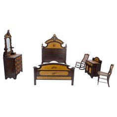 an antique bedroom furniture set including a bed, dresser and mirror