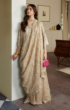 Golden Embellished Pakistani Wedding Dress in Raw Silk is a stylish masterpiece adorned with Hand-crafted details of Sequins, Beads, Sitara, and Motifs. Fancy Kaftan Dress, New Dresses Designs Pakistani, Sequin Gown For Eid Reception, Sequin Chinon Dress For Reception, Festive Chinon Dress With Sequins, Festive Sequin Dress In Chinon, Festive Sequined Chinon Dress, Eid Georgette Sequin Gown, Traditional Drape Gown With Sequins For Eid