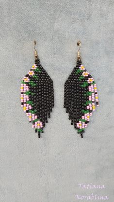 These handmade unique earrings with abstract floral print are made of high-quality Czech beads and strong synthetic thread. I use my author's scheme . They are elegant, fashionable, and highly versatile, suitable for everyday wear. Color:black and pink,yellow,green, lilac. 100% hand made with love! Measurements: Length-9 cm (3.54 inch) (with schwenze) , Width -3 cm (1.18 inch) Materials: Silver plated ear hooks Czech glass beads Nylon Thread Unique Handmade Black Earrings, Black Flower-shaped Jewelry With Colorful Beads, Handmade Black Dangle Earrings, Black Bohemian Earrings With Ear Wire, Unique Black Beaded Dangle Earrings, Unique Black Beaded Earrings, Black Bohemian Beaded Earrings As Gift, Black Bohemian Beaded Earrings For Gift, Traditional Black Chandelier Earrings With Dangling Beads