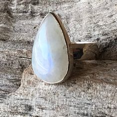 "Moonstone ring set in sterling silver bezel comes as blue flash teardrop gemstone healing statement jewelry for men and women. It measures apx. 25 mm in length and 15 mm in width. Natural finest grade untreated raw Rainbow Moonstone with a lovely blue fire flash  Open back to allow the gemstone healing energies to its wearer  Designed to suit all age and gender, in a crystal associated with 'the Moon'...Suitable gift for all occasions...Anniversary gift Birthday gift , engagement ring jewelry, wedding gift hallmark 925.  Size 9.5 Healing- Rainbow moonstone is a gemstone for \"New beginnings\", inner growth and strength. It soothes emotional instability and stress, and stabilizes the emotions, providing calmness.  Moonstone enhances intuition, promotes inspiration, success and good fortune Fine Jewelry With Cabochon Drop, Fine Jewelry Drop Cabochon, Fine Hypoallergenic Jewelry For Promise Ring, Hypoallergenic Fine Jewelry Ring, Fine Jewelry Moonstone Teardrop Ring, Fine Jewelry Teardrop Moonstone Ring, Adjustable Moonstone Jewelry With Round Stone, Spiritual Moonstone Ring Jewelry, Fine Jewelry Pear-shaped Moonstone Ring