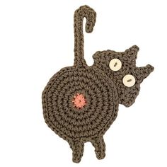 a crocheted cat hanging from a hook with eyes on it's back