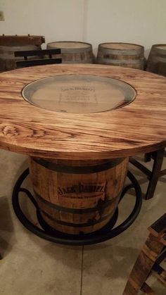 a table made out of wine barrels in a room