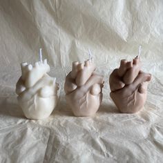 three candles shaped like the human heart