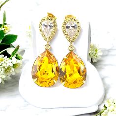 These timeless Swarovski Yellow Earrings have a Victorian touch of elegance and romance! A bright, happy and super sparkly jewelry that will light up your day!  I made the gorgeous Earrings with: - the Genuine and unique 18x13mm Swarovski Sunflower Yellow teardrop pear shaped fancy stones, set in gold plated settings - Hypoallergenic and tarnish resistant, 16k gold plated pear shaped ear posts with AAA cubic zirconia stones - these are approx 1 1/4" from top of the ear posts to bottom of the sto Yellow Teardrop Earrings For Wedding, Sparkling Stone Pear Earrings As Gift, Gold Pear-shaped Bridal Earrings With Prong Setting, Pear-shaped Earrings With Sparkling Stones For Gift, Gold Crystal Clip-on Earrings For Gift, Pear-shaped Crystal Earrings As A Gift, Pear-shaped Crystal Earrings Gift, Gold Clip-on Earrings With Sparkling Stones, Yellow Teardrop Wedding Jewelry