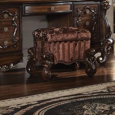 an ornate wooden desk and chair in a room