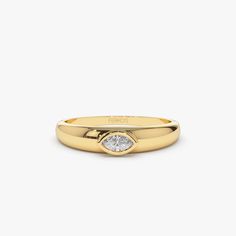 a gold ring with a white diamond