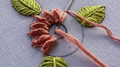 a close up of a piece of yarn with leaves on it