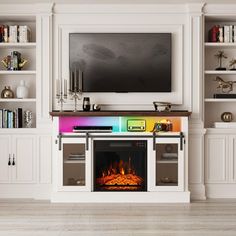 a living room with white bookcases and a television mounted above the fire place