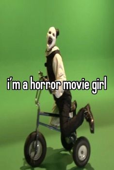 a man in a clown mask riding a tricycle with the words i'm a horror movie girl on it