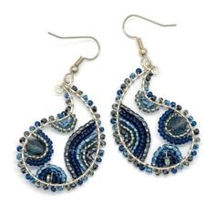 the earrings are made with blue beads and silver wire, which is hanging from hooks