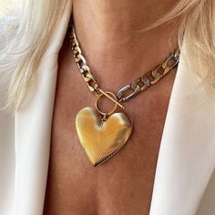 "This oversized gold heart pendant hangs from a statement figaro link chain with a toggle clasp closure! This chunky necklace is a must-have whether you plan to layer or style it solo.  Details * Stainless steel chain 11.5mm mixed gold and silver links. Water Resistant, Tarnish Free, Hypoallergenic * Chain Style: Figaro * Chain thickness: 2.5mm   * Different Chain lengths, from 16\" to 22\" inches long including the toggle closure. Choose the length from the dropdown menu. * Gold-plated brass he Luxury Artisan Heart Necklace, Gold Heart Pendant, Open Heart Necklace, Necklace Love, Large Heart, Heart Pendant Gold, Link Chain Necklace, Puffy Heart, Necklace Statement