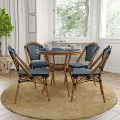 a round table with four chairs around it