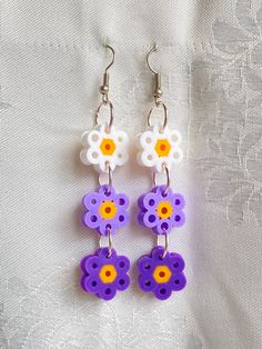 Perler bead dangle earrings. Brandishes three dainty flowers in descending color variations. Dangle Earrings With 3d Flowers, Dainty Flowers, Bead Dangle Earrings, Beaded Dangle Earrings, Perler Bead, Beaded Dangles, Perler Beads, Jewelry Earrings Dangle, Color Variations