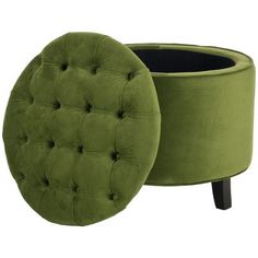 a green round ottoman sitting on top of a wooden table