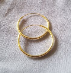 The absolute classic: the Creole, always elegant and beautiful! Material: 925 sterling silver gold plated Diameter: 25mm, Hollow Wire Thickness: 1.5mm Closure: the classic sliding closure Shape: round Please note: These classic hoop earrings are made of a hollow wire. To close it, the thinner wire must be pulled through the earlobe and then inserted into the hollow wire. If the creole stays in the ear for a long time, this clasp is very suitable because the earrings do not come open quickly, whi Adjustable Gold Plated Jewelry With Spring Ring Clasp, Adjustable Tarnish Resistant Hoop Jewelry, Elegant Nickel-free Gold Rings, Everyday Round Brass Jewelry, Matte Gold Brass Jewelry For Anniversary, Everyday Brass Jewelry, Classic Rose Gold Brass Jewelry, Hypoallergenic Yellow Gold Brass Jewelry, Adjustable Round Band Gold-plated Jewelry