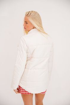 Wrap yourself in style this season with our Cream Puffer Jacket! Featuring a white puffer design and red gingham bows, this jacket is both trendy and functional. Perfect for keeping you warm and stylish all winter long! All orders are currently shipping within 14 business days. To receive item quicker, expedited shipping is available at checkout. Quilted White Outerwear For Cold Weather, White Quilted Outerwear For Cold Weather, White Casual Quilted Jacket For Cold Weather, White Quilted Casual Outerwear, Fitted White Puffer Jacket For Winter, Fitted White Puffer Jacket For Fall, White Quilted Jacket For Cold Weather In Fall, White Quilted Jacket For Spring, White Quilted Puffer Jacket For Cold Weather