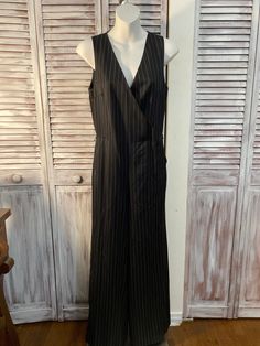 one piece Ralf Lauren from the 90s one piece black white striped with wide leg size 2 Measure Bust 34 inches Size 28 inches Inside leg 30.5 inches Width of the bottom of the pants 11.5 Elegant Striped Sleeveless Jumpsuits And Rompers, Striped Fitted V-neck Jumpsuit, Striped Fitted V-neck Jumpsuits And Rompers, Chic Fitted Jumpsuits And Rompers With Vertical Stripes, Chic Striped Jumpsuits And Rompers For Work, Fitted Jumpsuits And Rompers With Vertical Stripes, Fitted Striped Sleeveless Jumpsuits And Rompers, 90s One Piece, One Piece Black