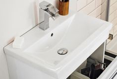 a white sink with red trim and chrome faucet next to it in a bathroom