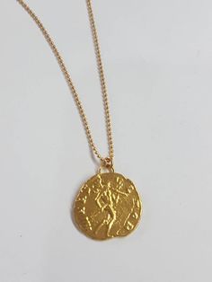 Coin pendant necklace, 14k gold necklace, antique coin necklace, gold coin necklace, gold delicate necklace, antique necklace, Roman coin This gold coin necklace was 100% handmade and has an antique Roman coin for a pendant. The necklace is 14k gold filled chain with a 14k gold plated coin pendant. It is also available in sterling silver (polished or oxidized as in the last photo). Dimensions: The 14k gold necklace is available in multiple lengths. The antique coin pendent's diameter is 1.5 cm ( Engraved Brass Medallion Coin Necklace, 14k Gold Amulet Coin Necklace Tarnish Resistant, Yellow Gold Medallion Coin Necklace In Brass, Gold Medallion Amulet Coin Necklace, Yellow Gold Medallion Necklace With Coin Pendant, 14k Gold Medallion Necklace Amulet Style, 14k Gold Medallion Amulet Necklace, 14k Gold Round Pendant Amulet Coin Necklace, Vintage Yellow Gold Brass Coin Necklace