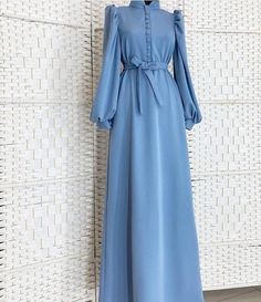 Lined with buttons and elegant cuff sleeves, this abaya dress is a must-have! Elegant Blue Long Sleeve Abaya, Elegant Long Sleeve Blue Abaya, Elegant Long Dress Abaya For Eid, Wedding Dresses For Eid, Elegant Long Maxi Dress With Modesty Panel, Elegant Solid Color Abaya With Modesty Panel, Elegant Solid Color Dresses For Eid, Elegant Long Sleeve Maxi Dress For Eid, Elegant Long Sleeve Maxi Dress With Modesty Panel