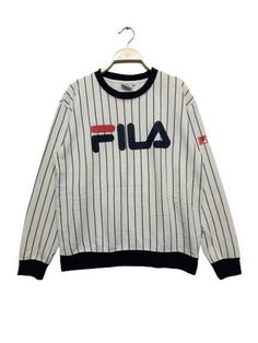 "ACTUAL MEASUREMENTS    ➡️Label: Fila    ➡️Size on Tag: L    ➡️Armpit to Armpit: 21 \"inch    ➡️Collar to hem (Lenght): 25 \" inch    ➡️Colour: White    ➡️Material: view picture's    ➡️PLEASE CHECK THE MEASUREMENTS CAREFULLY AND MAKE SURE THE ITEMS MATCH YOUR BODY ⬅️    ➡️Condition: Used & Vintage item.    ➡️All details: View picture's    📌ATTENTION     All previously used items except those specified. Please understand the state of the item    📌PAYMENT    Receives only 'PAYPAL'    📌OTHERS Striped Crew Neck Top With Logo Print, Striped Crew Neck Sweatshirt For Streetwear, Sporty Striped Crew Neck Sweatshirt, Sporty Striped Winter Tops, Sporty Striped Tops For Winter, Winter Sporty Striped Tops, Vintage Military Jacket, Fendi Scarf, Body Condition