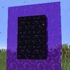 a purple and black object sitting in the middle of a field