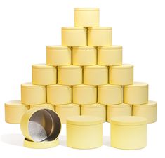 a stack of yellow round containers with one empty container next to it and the other half full