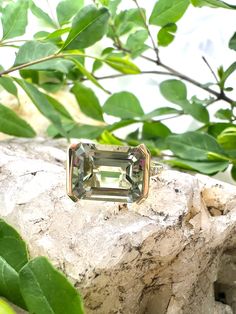 This beautiful 5-carat Green Amethyst ring features 0.06-carat diamonds set in timeless yellow gold. The vivid hue of the Green Amethyst will be sure to turn heads and give a unique twist to any outfit. This ring features:-5.00 carat Green Amethyst-0.06 carat Diamond-14KT Yellow Gold Can be made in any sizeStyle #200-00406 Luxury Gold Ring With Green Amethyst, Luxury Yellow Gold Amethyst Ring With Emerald Cut, Luxury Yellow Gold Rings With Green Amethyst, 14k Yellow Gold Emerald-cut Amethyst Ring, Yellow Gold Emerald-cut Amethyst Ring For Formal Occasions, Heirloom Emerald Ring With Gemstone Accents For Formal Events, Formal Green Amethyst Ring With Gemstone Accents, Green Amethyst Ring For Formal Occasions, Elegant Octagon Amethyst Ring For Formal Occasions