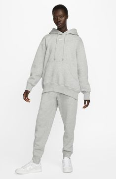 Exaggerated features like an oversized kangaroo pocket and extra tall ribbing add to the roomy feel of this sporty hoodie with a cozy brushed fleece interior. Drawstring hood 80% cotton, 20% polyester Machine wash, dry flat Imported Oversized Hooded Sports Sweats, Oversized Hooded Sweats For Sports, Relaxed Fit Hooded Cozy Sweats, Cozy Hooded Sweats With Relaxed Fit, Cozy Relaxed Fit Hooded Sweats, Cozy Hoodie With Kangaroo Pocket For Loungewear, Cozy Loungewear Hoodie With Kangaroo Pocket, Nike Sweats For Winter Streetwear, Nike Winter Sweats For Streetwear