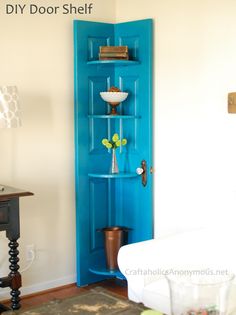 a living room with a white couch and blue bookcase