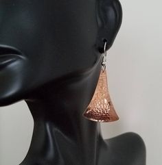 Hammered copper earrings with a sterling silver ear wire. The hammering technique I do domes them slightly for a nice effect, and hardens the metal a little so they hold their shape well. They are available in size small, 7/8ths of an inch long, medium, 1&1/4 inch long, and large 1&5/8ths of an inch. That is the length of the hammered piece. The ear wire adds about a 1/2 inch. They are not heavy. Shipped in a gift box to protect during shipment. I also have this style listed in sterling Hammered Copper Drop Earrings, Hammered Copper Earrings For Gift, Hammered Silver Copper Earrings, Hammered Silver Earrings Made Of Copper, Silver Hammered Copper Earrings, Hammered Rose Gold Copper Earrings, Rose Gold Hammered Dangle Earrings, Rose Gold Hammered Metal Earrings, Hammered Rose Gold Brass Earrings