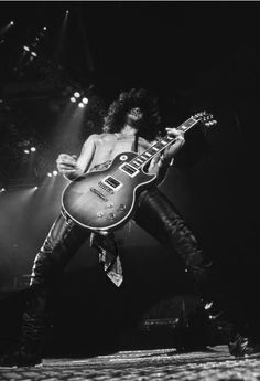 a man with an electric guitar on stage