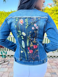 Ornate, stylish and comfortable blue or black denim jacket with overlay of intricate flowered lace design that is sewed strategically onto the jacket. Studs are applied to add style and brilliance. There is an option for rhinestone fringes.  And this is handmade, unique and one of a kind!  Express yourself with one of these fashionable jackets that will be custom designed for you!  Made with love and to bring out the beauty you have inside! Fitted Floral Print Denim Jacket, Bohemian Dark Wash Denim Jacket For Spring, Embroidered Dark Wash Denim Jacket For Spring, Fitted Denim Outerwear With Floral Embroidery, Spring Embroidered Dark Wash Denim Jacket, Fitted Blue Denim Jacket With Floral Embroidery, Spring Embellished Medium Wash Denim Jacket, Embellished Medium Wash Denim Jacket For Spring, Embellished Blue Denim Jacket For Spring