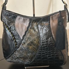 Beautiful Black Sharif Shoulder Bag. Mrp $300.00 Interior Is All Leather And In Perfect Condition. This Bag Looks Brand New. Ostrich Embossed On Both Sides And Bottom. Blends Of Snake And Alligator Designs With Golds Running Through The Color. Excellent Condition. Great Everyday, Sturdy Bag. Clean No Rips Or Orders. Very Classic Mid Sized Bag With A Zipper Closure. Interior Pocket With Zipper. Clean Looks New. No Odors Or Questions? Leave A Comment Below! Black Leather Bag With Crocodile Pattern, Elegant Black Hobo Bag With Leather Backing, Elegant Black Leather Hobo Bag, Black Textured Leather Rectangular Hobo Bag, Black Rectangular Textured Leather Hobo Bag, Emboss, Alligator, Bag Lady, Shoulder Bag