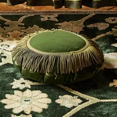 a green cushion sitting on top of a rug