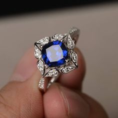 This is a gorgeous handmade creation. Its beauty is its simplicity & Elegance. The 7*7 mm cushion shape faceted lab sapphire is crafted in solid sterling silver and with rhodium plated. All item is sent in a beautiful gift box If you have any idea of design your ring,pls contact me directly. You can realize more lovely stuff clicking the link https://www.etsy.com/shop/knightjewelry?refshopsection_shophome_leftnav Please leave the correct address and you phone number for delivering successfully. Blue Sapphire Engagement Ring Halo, Blue Wedding Rings, September Birthstone Ring, Diamond Sapphire Engagement Ring, Sapphire Diamond Engagement, September Birthstone Rings, Blue Gemstone Rings, London Blue Topaz Ring, Sapphire Engagement Ring Blue