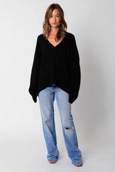 STYLE INFORMATION: The Leila Black V-Neck Oversized Sweater is the sweater of the season! Black knit fabric shapes an oversized sweater with a V-neckline and long, relaxed sleeves. Features ribbed knit neckline, cuffs, and hemline. DETAILS & CARE: Acrylic. Hand wash cold. Imported. SHIPPING: We offer free shipping for all orders in the Continental US. Oversized V Neck Sweater Outfit, Jumper Outfit Women, Vneck Sweater Outfit, Oversized Black Knit Sweater, Cute Oversized Sweater, Black Crochet Sweater, Black Sweater Outfit, Oversized Black Sweater, Knit Clothes