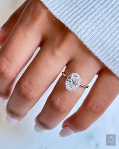 a woman's hand with a diamond ring on it