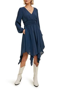 A fit-and-flare dress offers contemporary style with puffed balloon sleeves, a smocked waist, handy pockets and a flowy handkerchief hem. Slips on over head Surplice V-neck Long sleeves Partially lined 100% polyester Hand wash, dry flat Imported Model stats: 5'10" height, 32" bust, 25" waist, 36" hip. Model is wearing size Small. Flowy Midi Dress With Ruffle Asymmetrical Hem, Flowy Midi Dress With Asymmetrical Ruffle Hem, Fall Midi Dress With Billowy Ruffle Hem, Fall A-line Ruched Dress, Billowy Long Sleeve Midi Dress With Ruffle Hem, Billowy Long Sleeve Midi Dress With Smocked Cuffs, Billowy Long Sleeve Casual Midi Dress, Billowy Long Sleeve Midi Dress, Long Sleeve Midi Dress With Smocked Cuffs