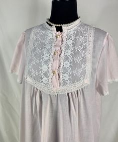 "~ Cute short sleeved Lewis Frimel nightgown in a pretty pale pink ~ Lace details at collar lined with fabric ~ Lace trim at sleeve cuffs ~ Three plastic buttons at chest ~ Made in USA CIRCA: 1980's MATERIALS: No label, probably a cotton/poly blend LABEL: Lewis Frimel CONDITION: Very good - no rips or holes.   MEASUREMENTS:  Vintage sizes are NOT the same as modern sizes.  Please go by the given measurements for a garment and not any listed size when determining fit! ~ No Size tag Shoulder ~ 15.5\" Sleeve ~ 8\" Bust ~ 44\" Length ~ 39\" shoulder to hem At this time I CANNOT ship internationally. I can only ship to US addresses. Excessive shipping charges will be refunded. PLEASE convo me if you have any further questions about this item or would like to see more pictures.  I try to be as a Elegant Short Sleeve Nightgown For Bedtime, Spring Nightgown For Pajama Party With Short Sleeves, Spring Short Sleeve Nightgown For Pajama Party, Pink Short Sleeve Sleepwear For Spring, Feminine Nightgown With Lace Trim For Home, Feminine Lace Trim Nightgown For Home, Spring Short Sleeve Nightgown For Bedtime, Spring Short Sleeve Nightgown For Sleepovers, Short Sleeve Nightgown For Spring Sleepover