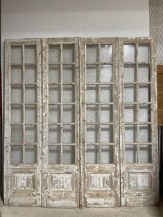 an old white wooden window with glass doors