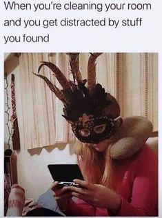 a woman wearing a masquerade while looking at her cell phone and texting