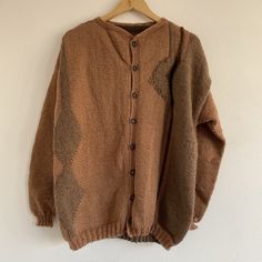 "Vintage 80s Brown Hand Knitted Abstract Button Up Wool Cardigan  Beautiful 1980s geometric patterned cardi! Mid weight, chunky handmade knit. Rusty brown terracotta with beige abstract patterns.  Button down with crew neck collar.  Hippie / cottage / boho style.  Recommended fit: Large / up to UK 16 or over sized on smaller sizes.  In good vintage condition.  Possibly wool & acrylic blend - no care labels. Soft material - not itchy.  See all measurements below. Measurements: Length: 27\" Chest: Oversized Brown Buttoned Sweater, Oversized Brown Cardigan With Buttons, Brown Knit Sweater With Buttons, Vintage Chunky Knit Cardigan For Fall, Brown Knit Cardigan With Fair Isle Pattern, Brown Fair Isle Knit Cardigan, Oversized Vintage Knit Cardigan, Vintage Brown Cardigan For Winter, Vintage Brown Winter Cardigan