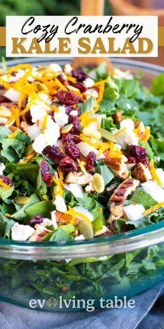 a close up of a salad in a bowl with cheese and cranberries on top