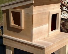 a wooden bird house sitting on top of a table